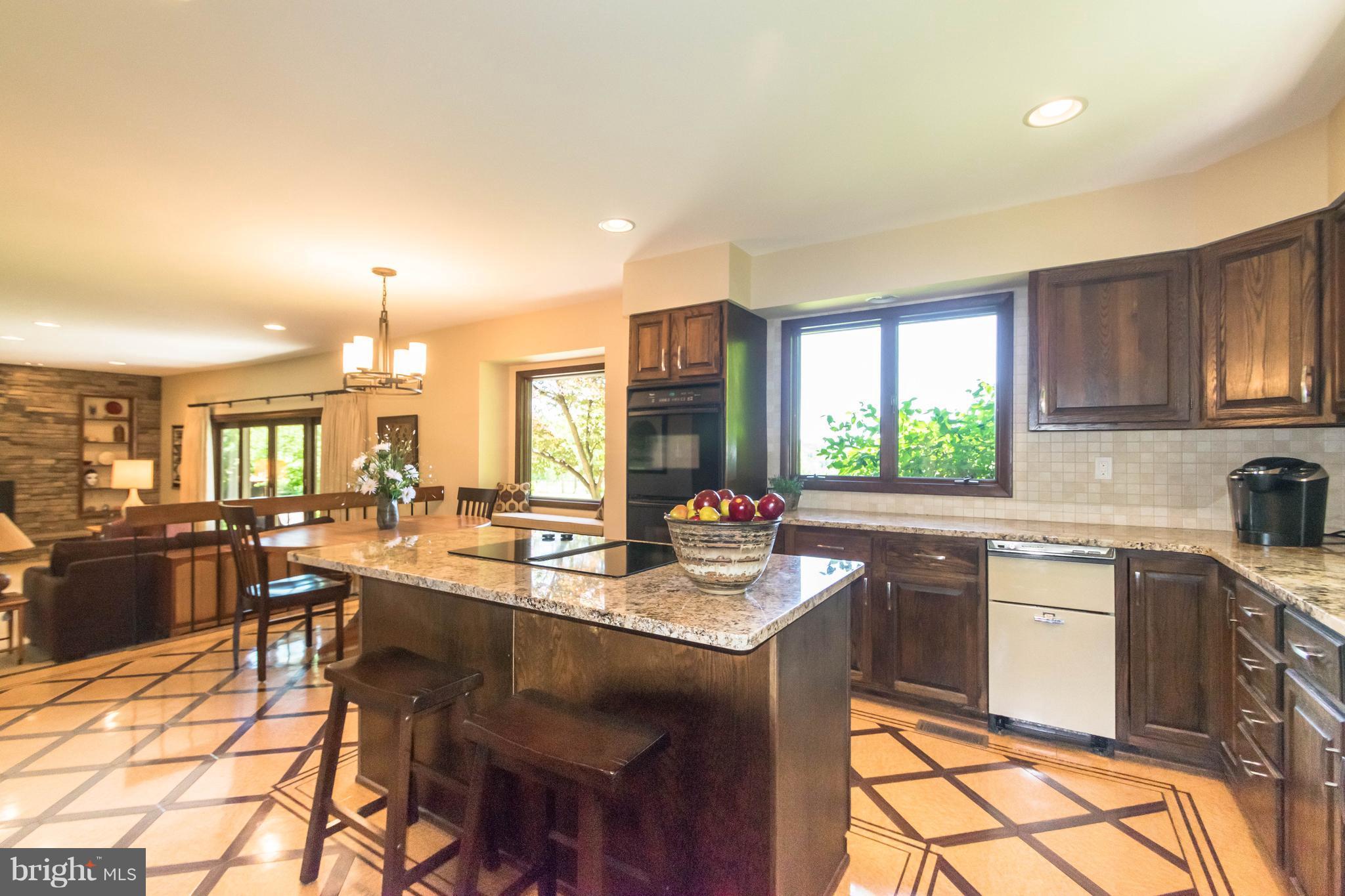 16520 York Road Monkton, MD 21111 - Photo 8 of 30 a kitchen with a stove a sink a dining table and chairs
