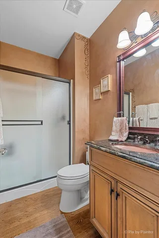 a dining room with furniture a chandelier and wooden floor