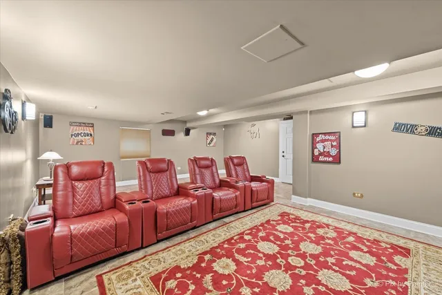 a front view of a house with garden and trees