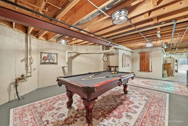 a view of a white house with a yard and a large tree