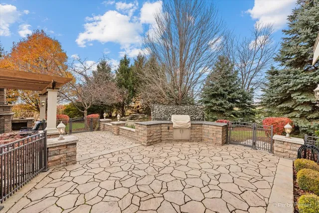 an aerial view of ocean and residential houses with outdoor space