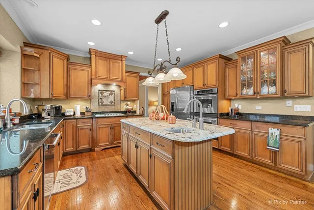 a dining room with furniture a chandelier and wooden floor