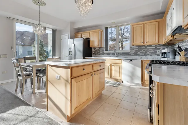 a kitchen with cabinets and chairs