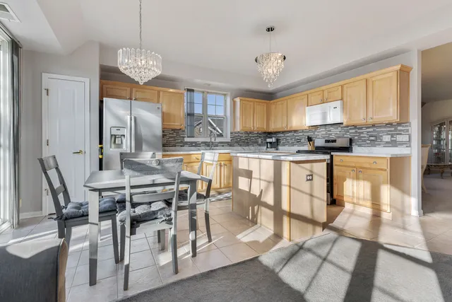 a view of a dining room with furniture a chandelier and wooden floor
