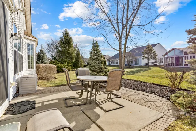a view of a patio with couches table and chairs and potted plants