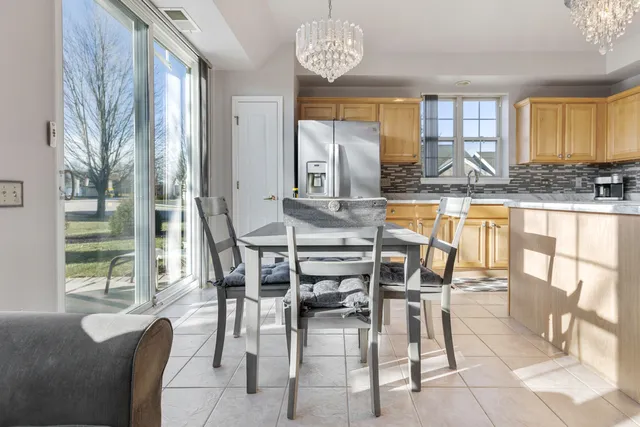 a view of a dining room with furniture a chandelier and wooden floor