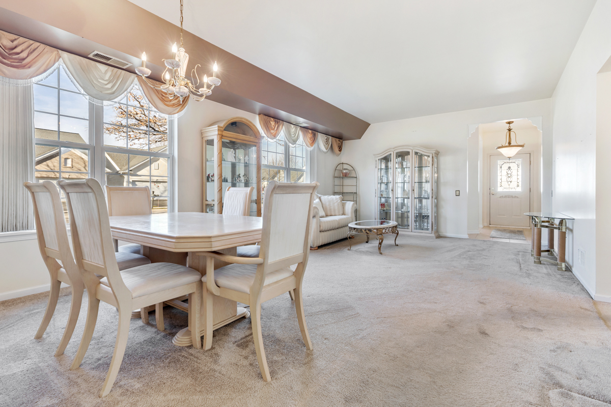 13567 Morgan Way Huntley, IL 60142 - Photo 23 of 26 a view of a dining room with furniture and chandelier