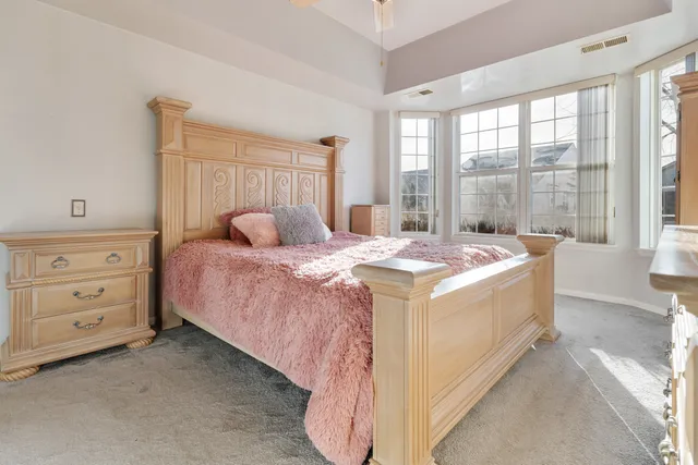 a bedroom with a bed and a dresser