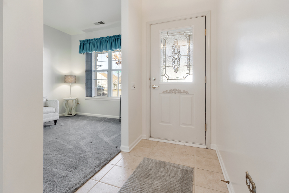 13567 Morgan Way Huntley, IL 60142 - Photo 5 of 26 a view of an empty room with a fireplace and a window