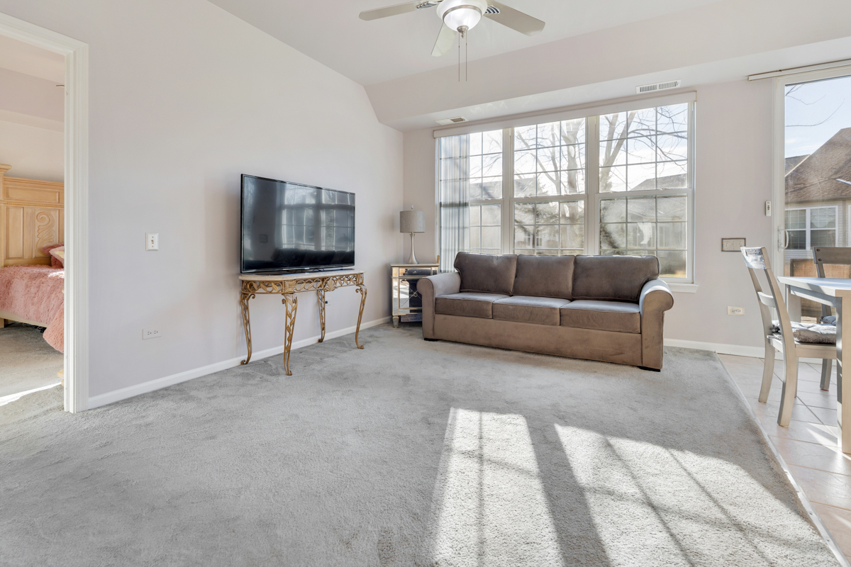 13567 Morgan Way Huntley, IL 60142 - Photo 10 of 26 a living room with furniture and a flat screen tv