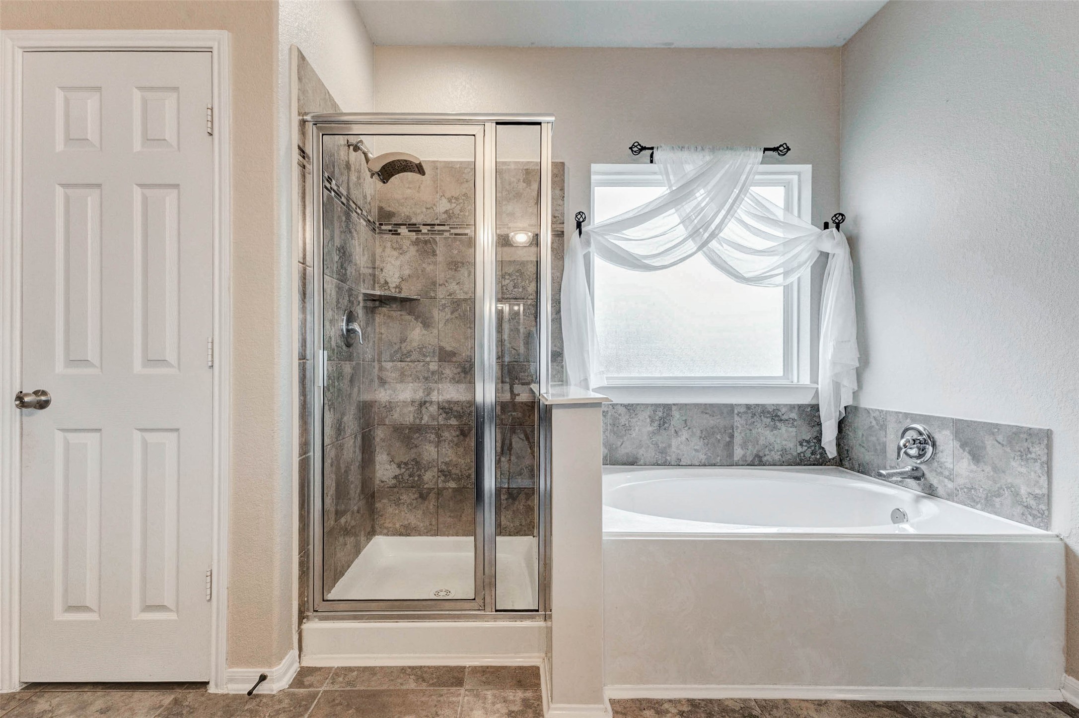 7638 Alum Lane Baytown, TX 77521 - Photo 25 of 44 a bathroom with a bathtub and a shower