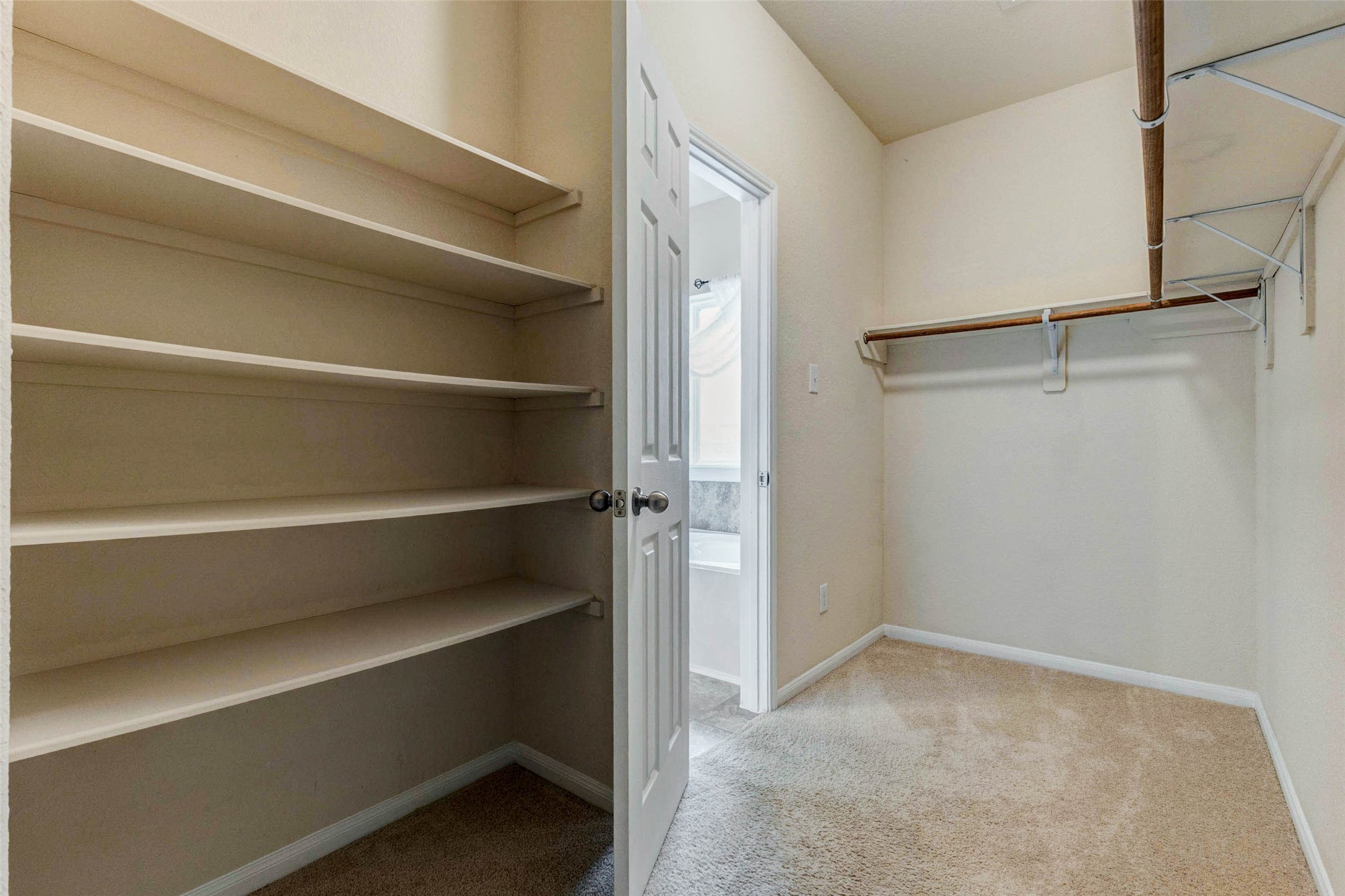 7638 Alum Lane Baytown, TX 77521 - Photo 27 of 44 a view of walk in closet with empty racks