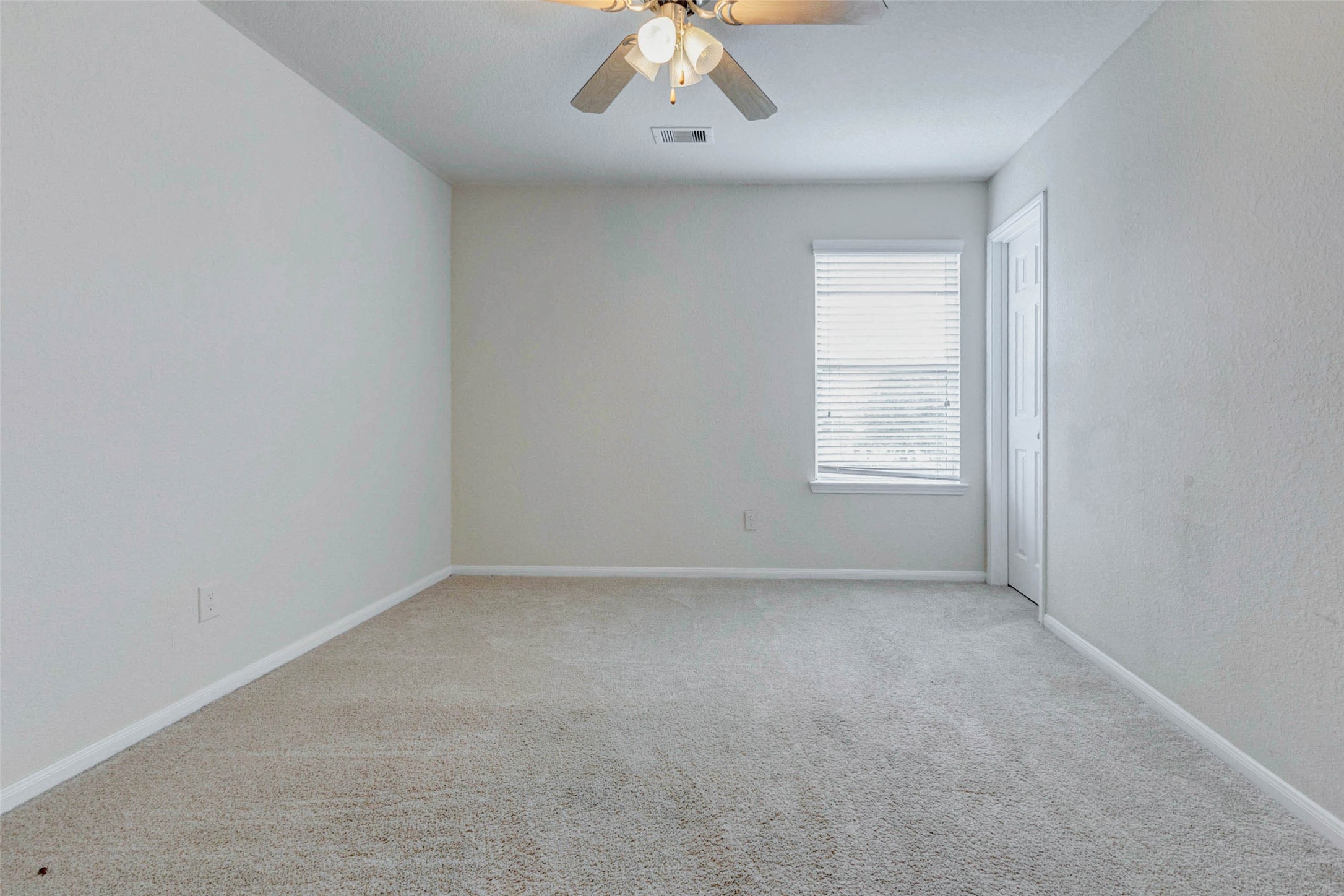 7638 Alum Lane Baytown, TX 77521 - Photo 29 of 44 an empty room with a chandelier fan and window