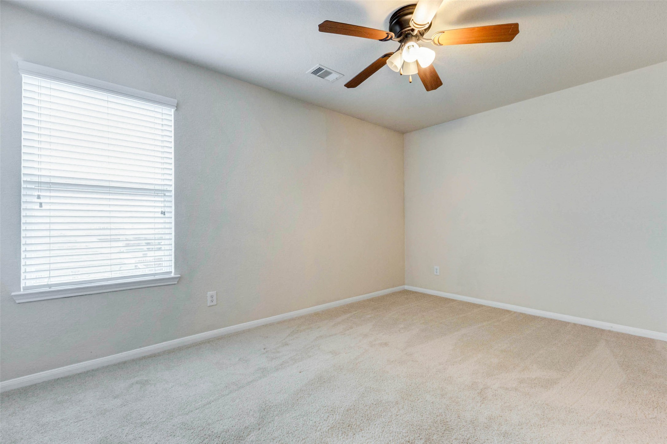 7638 Alum Lane Baytown, TX 77521 - Photo 31 of 44 an empty room with a window and a fan