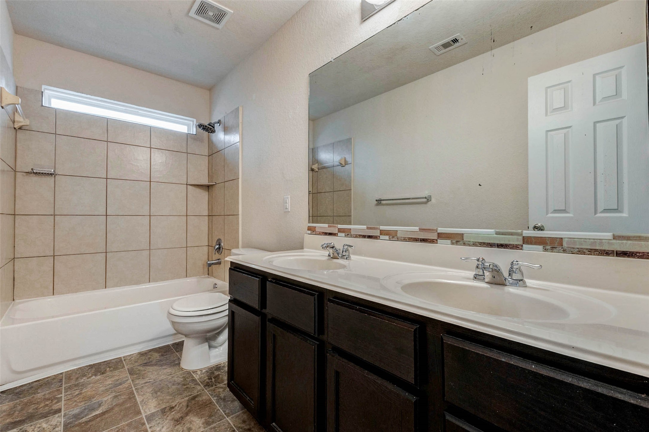7638 Alum Lane Baytown, TX 77521 - Photo 36 of 44 a bathroom with a sink a toilet a mirror and bathtub