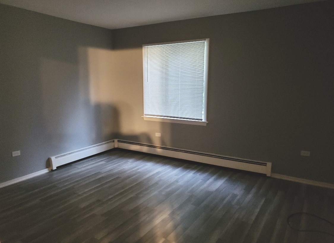 550 Michigan City Road, Unit 1C Calumet City, IL 60409 - Photo 5 of 6 an empty room with wooden floor and windows