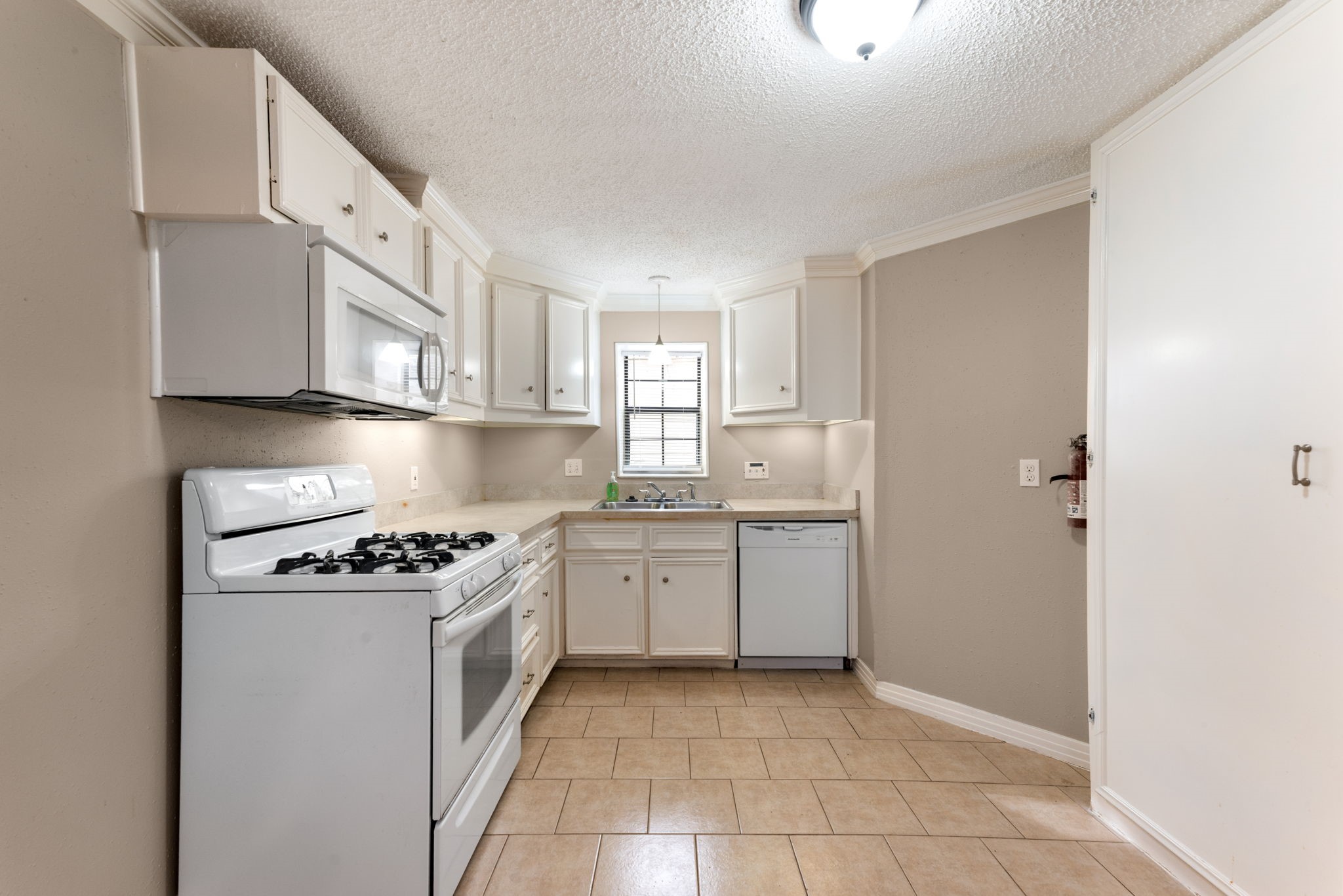 5311 Gano Street Houston, TX 77009 - Photo 11 of 35 a kitchen with granite countertop a sink a stove and cabinets