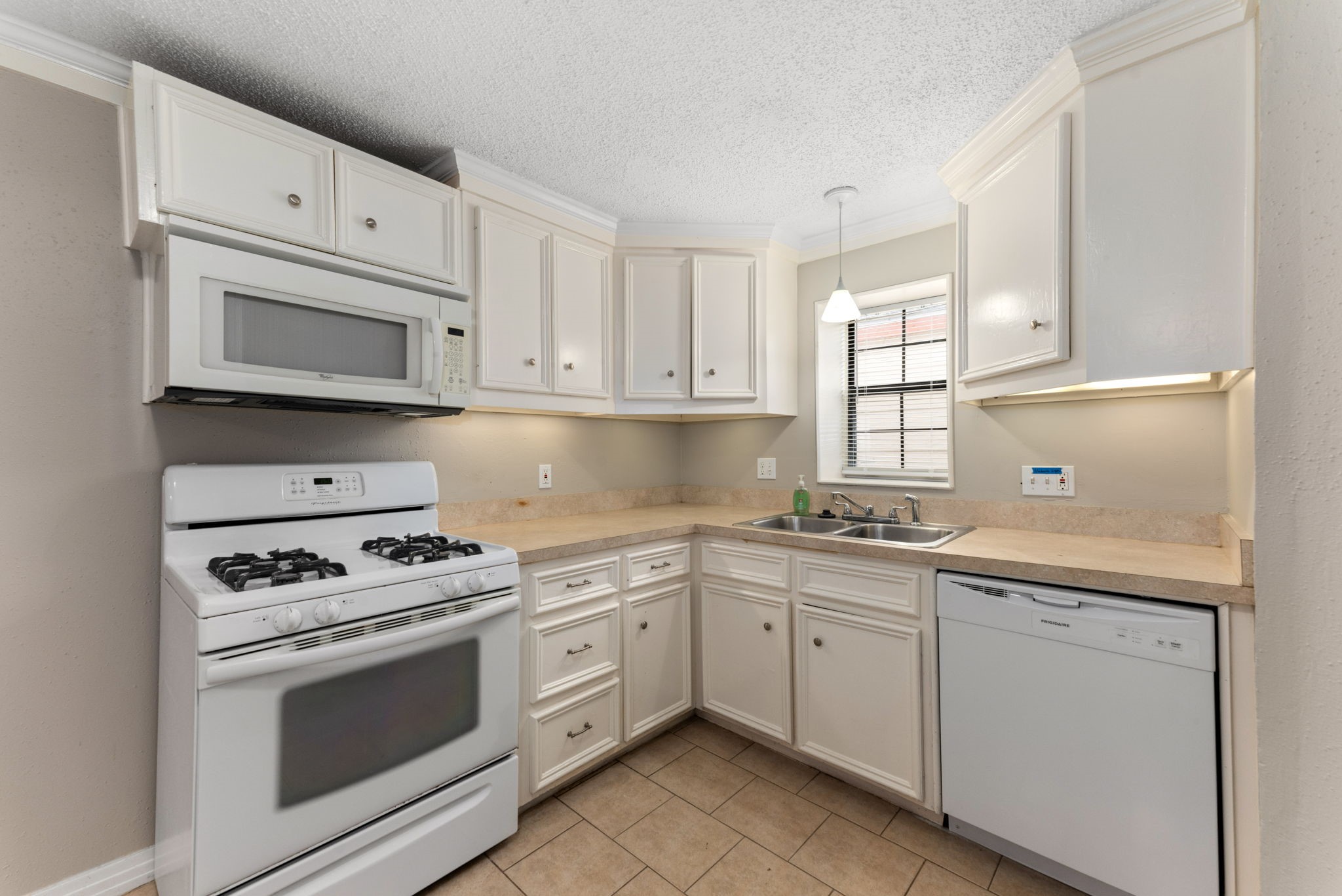 5311 Gano Street Houston, TX 77009 - Photo 12 of 35 a kitchen with cabinets appliances a sink and a window