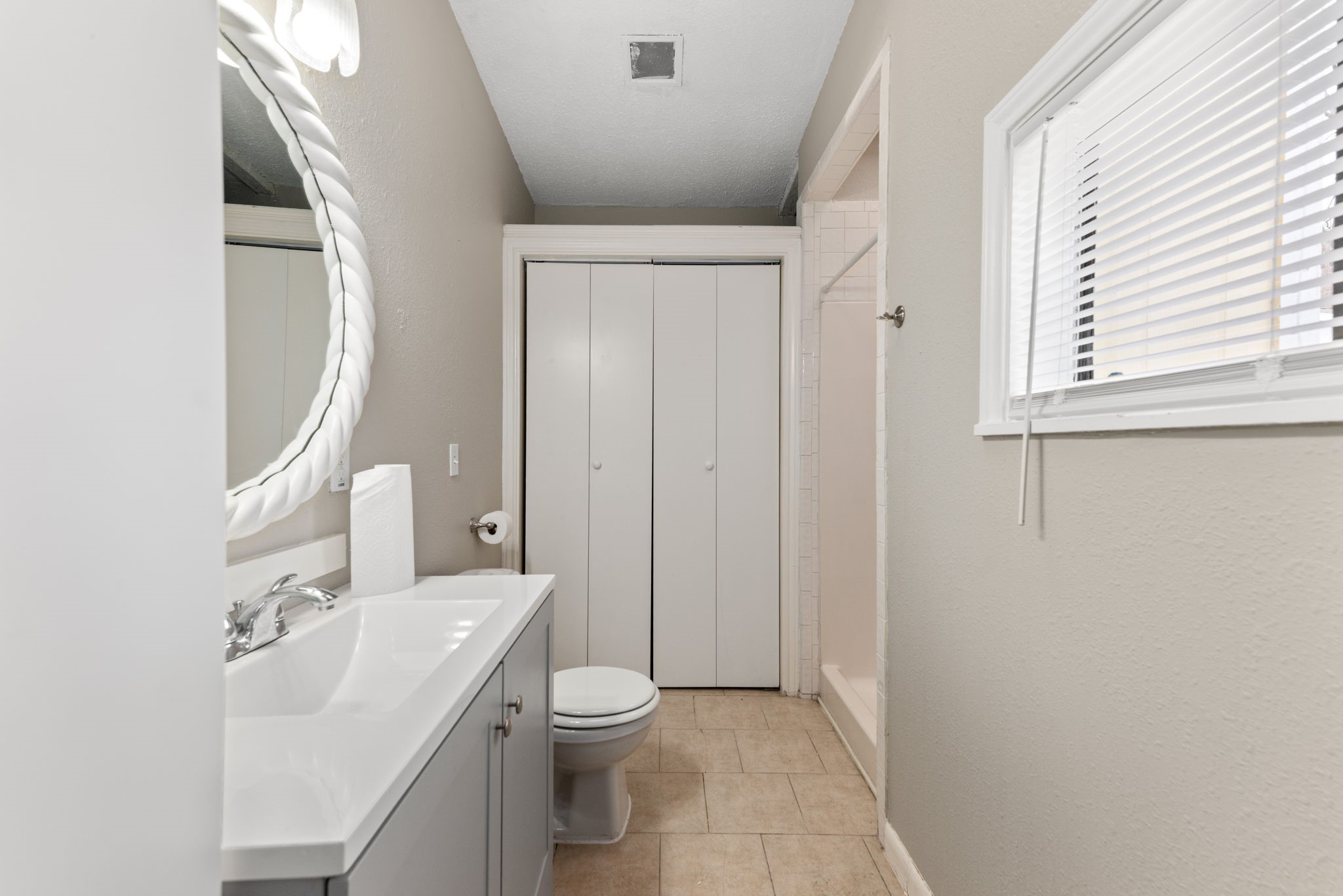 5311 Gano Street Houston, TX 77009 - Photo 24 of 35 a bathroom with a sink a toilet and a mirror