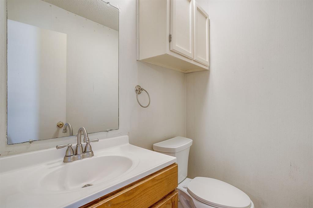3400 Sanguinet Street, Unit RIGHT Fort Worth, TX 76107 - Photo 8 of 22 a bathroom with a sink a toilet and a mirror