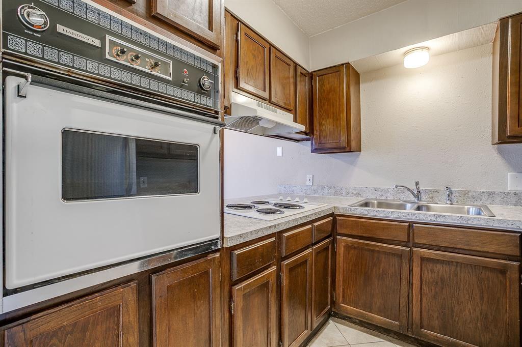 3400 Sanguinet Street, Unit RIGHT Fort Worth, TX 76107 - Photo 9 of 22 a kitchen with stainless steel appliances granite countertop a sink and cabinets