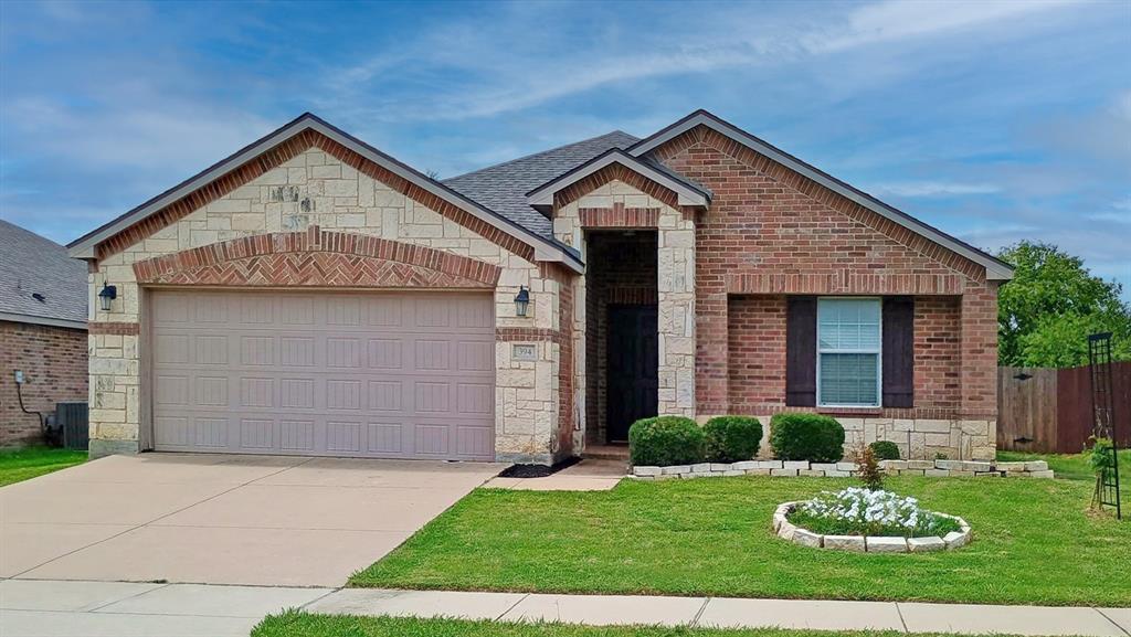 394 Meadow Ridge Drive Burleson, TX 76028 - Photo 1 of 1 View of front of property featuring stone siding, a garage, brick siding, and driveway
