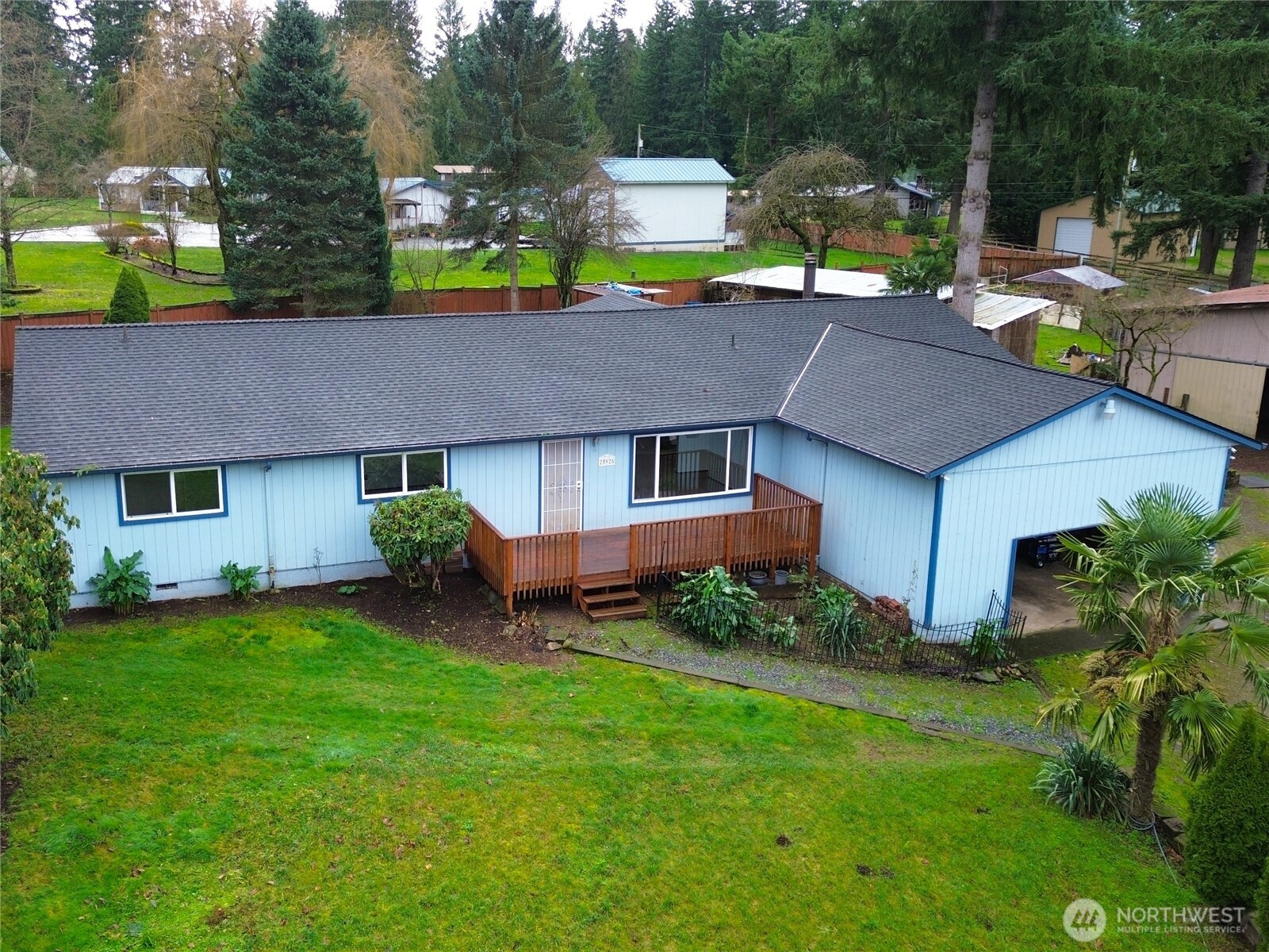 a aerial view of a house with swimming pool and garden
