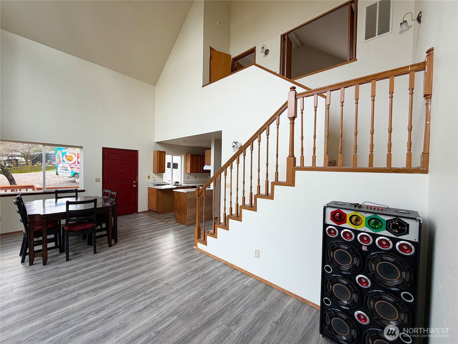 20925 260th Avenue Southeast Maple Valley, WA 98038 - Photo 26 of 34 a dining room with wooden floor stairs and a chandelier