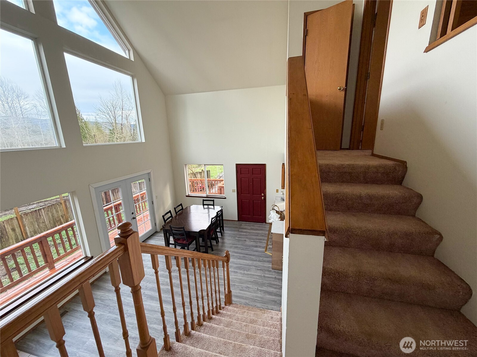 20925 260th Avenue Southeast Maple Valley, WA 98038 - Photo 27 of 34 a view of staircase with lots of frames on wall and a window