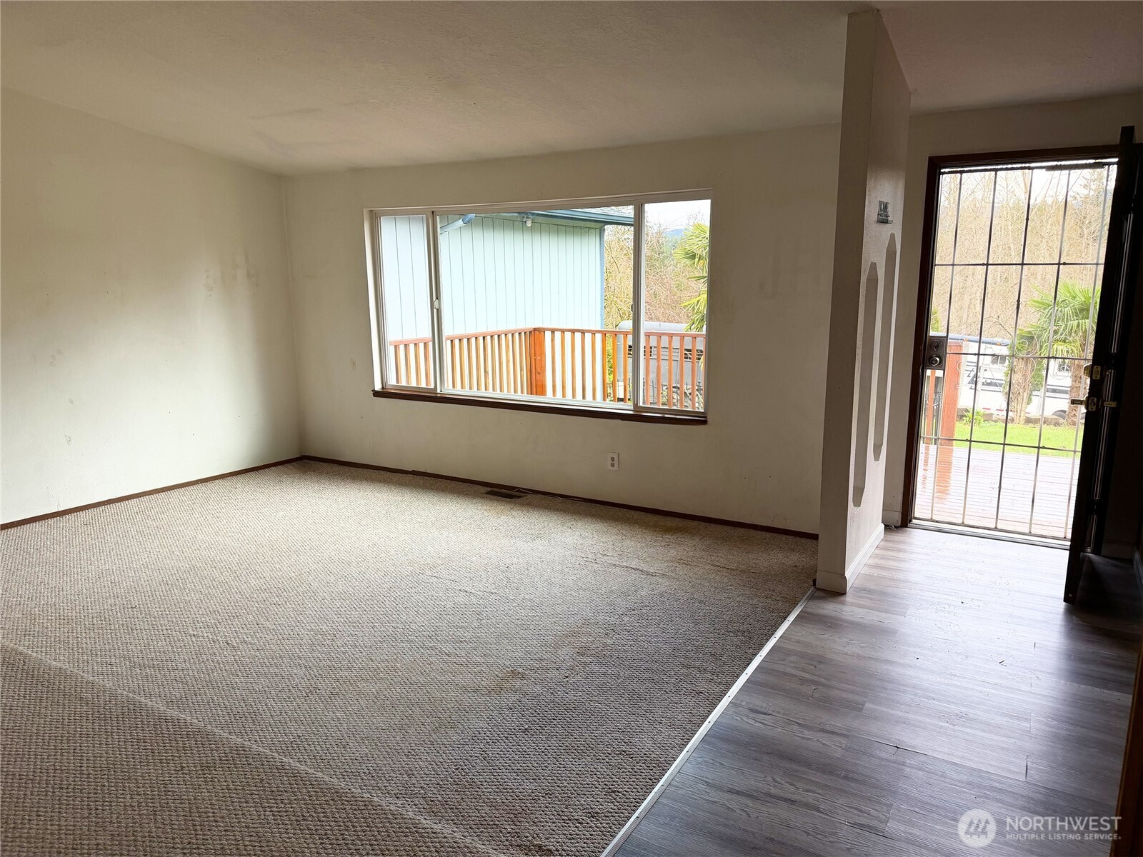 20925 260th Avenue Southeast Maple Valley, WA 98038 - Photo 5 of 34 an empty room with wooden floor and windows