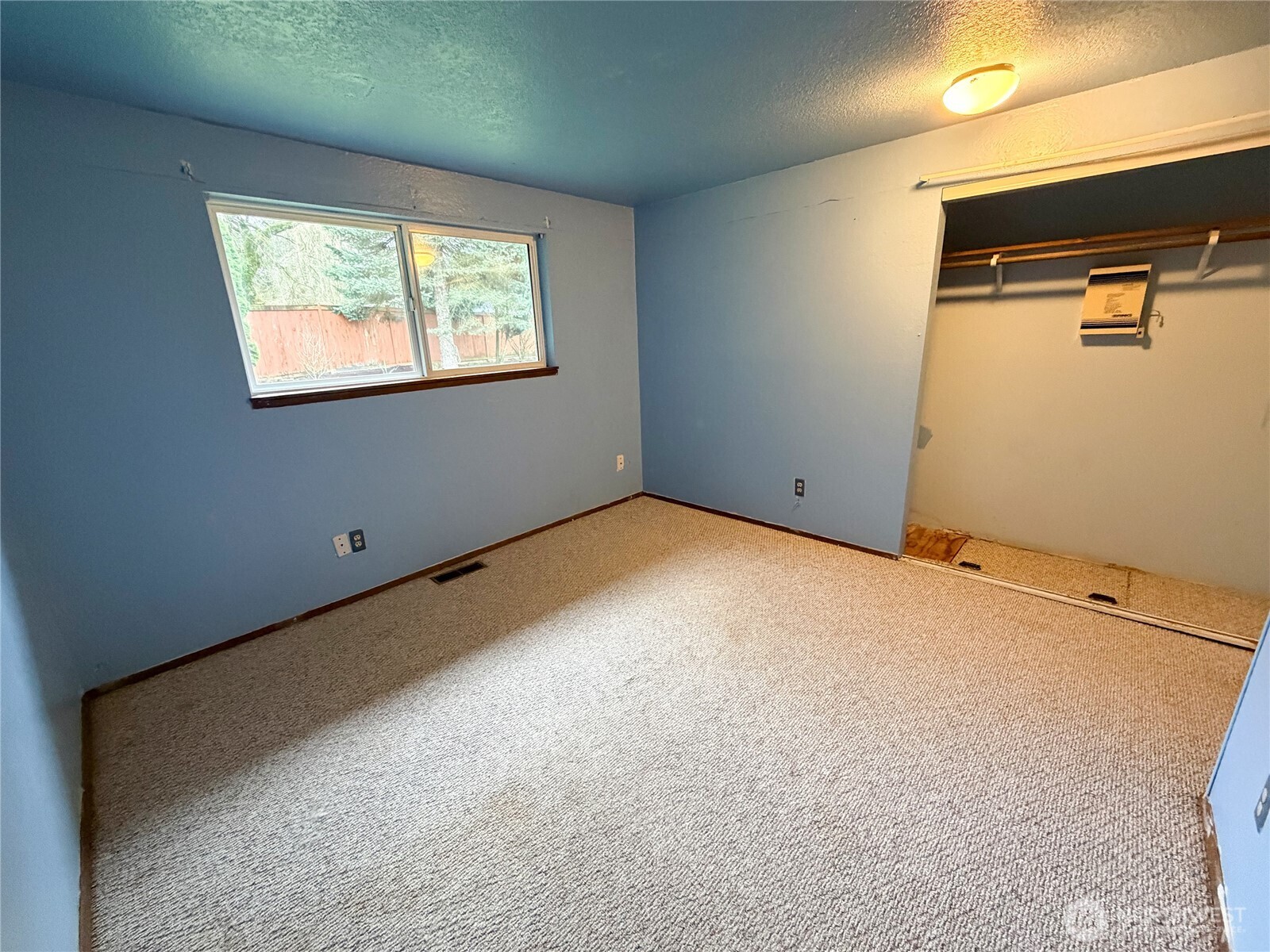 20925 260th Avenue Southeast Maple Valley, WA 98038 - Photo 9 of 34 a view of an empty room with windows