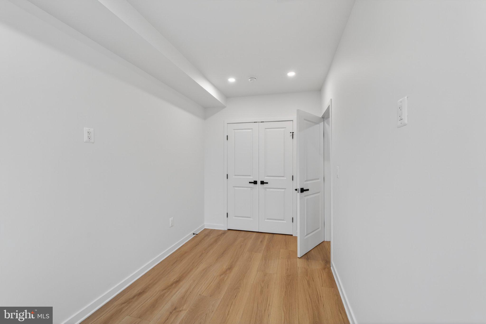 412 Newcomb Street Southeast Washington, DC 20032 - Photo 8 of 34 a view of a room with wooden floor and white walls
