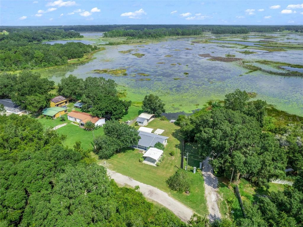 11495 Southeast 121st Lane Road Belleview, FL 34420 - Photo 31 of 31 a view of a lake and a yard