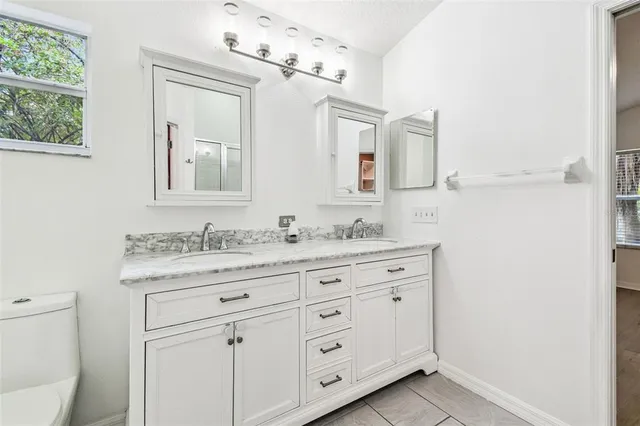 an empty room with a window and a ceiling fan