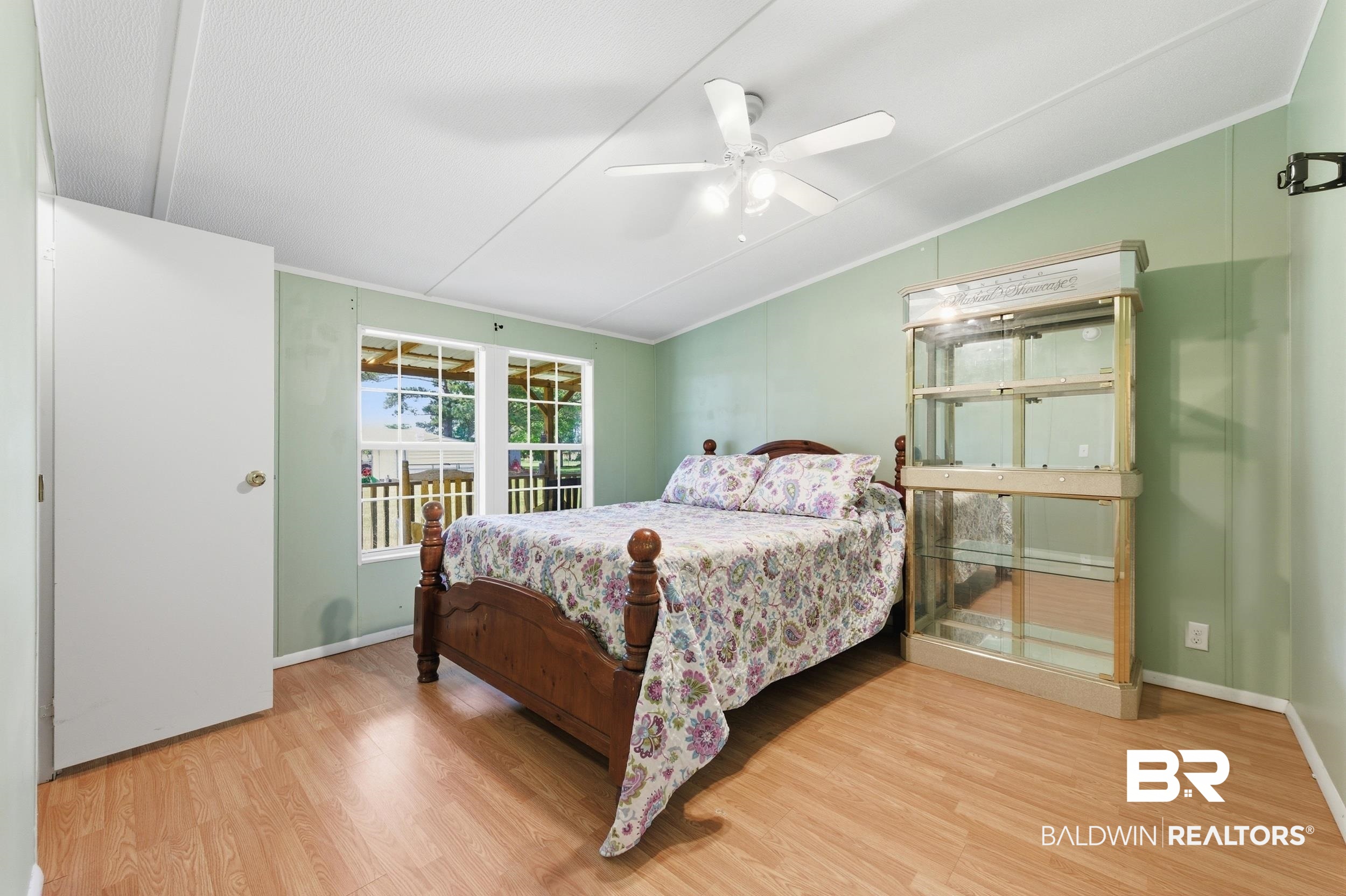 926 Tumbling Lane Atmore, AL 36502 - Photo 38 of 56 Bedroom with wood-finish flooring, two windows, and a ceiling fan