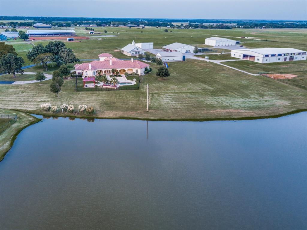 an aerial view of a house with a lake view