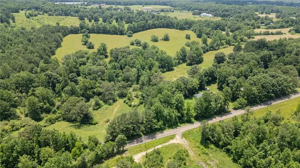 an aerial view of a house with a yard and lake view