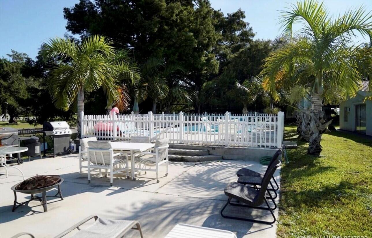 3203 Southeast 29th Lane, Unit 4 Okeechobee, FL 34974 - Photo 11 of 14 a view of a swimming pool with chairs