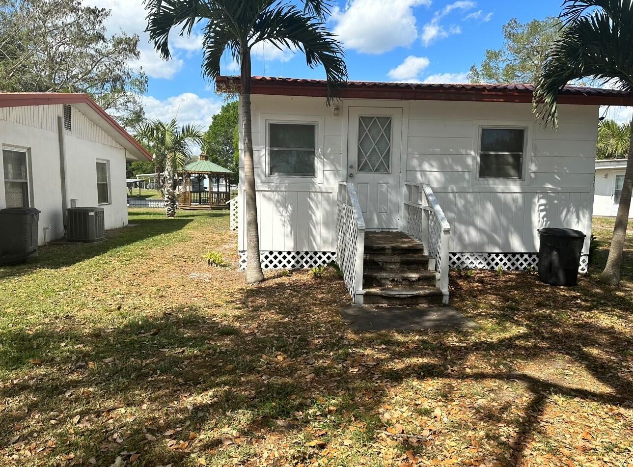 3203 Southeast 29th Lane, Unit 4 Okeechobee, FL 34974 - Photo 13 of 14 a front view of a house with a yard