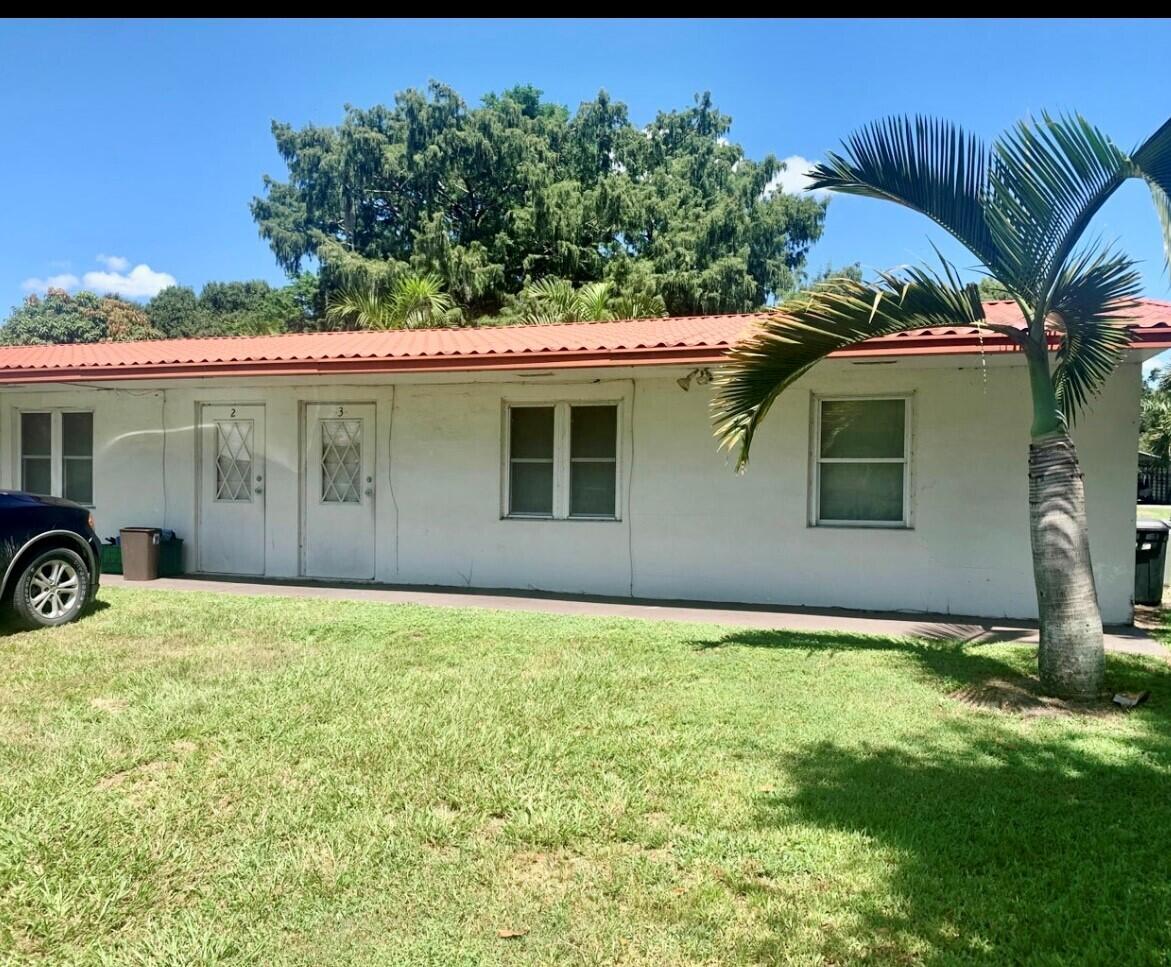3203 Southeast 29th Lane, Unit 4 Okeechobee, FL 34974 - Photo 3 of 14 a house view with a garden space