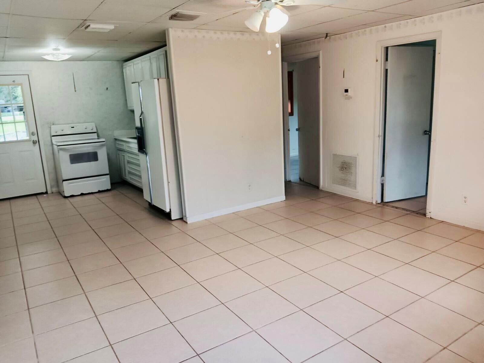 3203 Southeast 29th Lane, Unit 4 Okeechobee, FL 34974 - Photo 7 of 14 a view of a kitchen with an empty space and a refrigerator