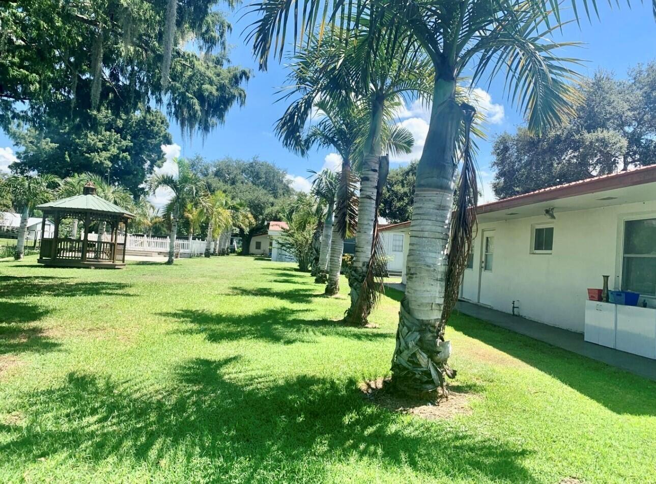 3203 Southeast 29th Lane, Unit 4 Okeechobee, FL 34974 - Photo 10 of 14 a view of a house with a yard