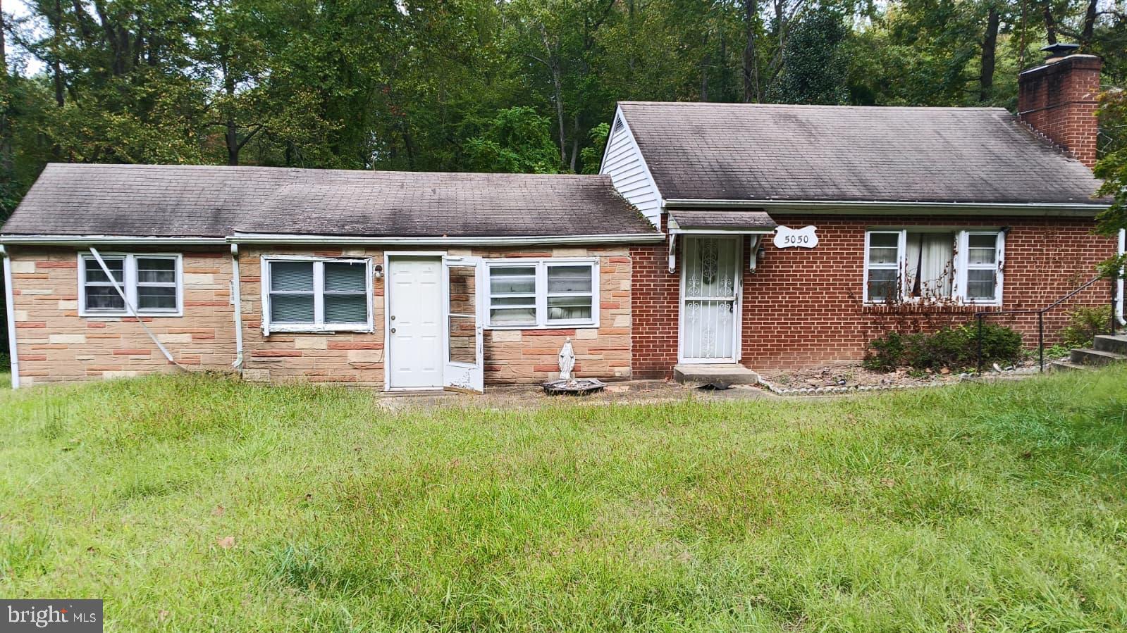 Charming brick home nestled in lush greenery.