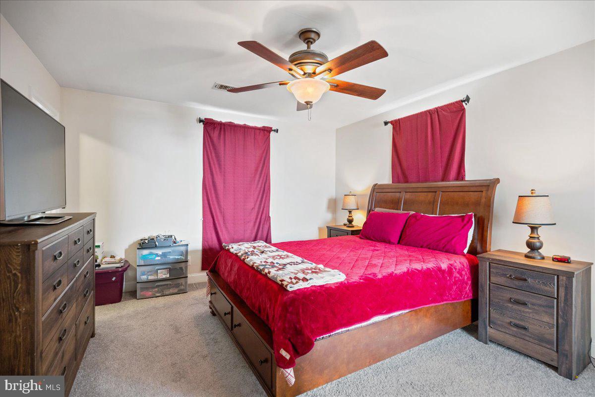 8255 Longpoint Road Baltimore, MD 21222 - Photo 46 of 54 a bedroom with a bed and a flat screen tv