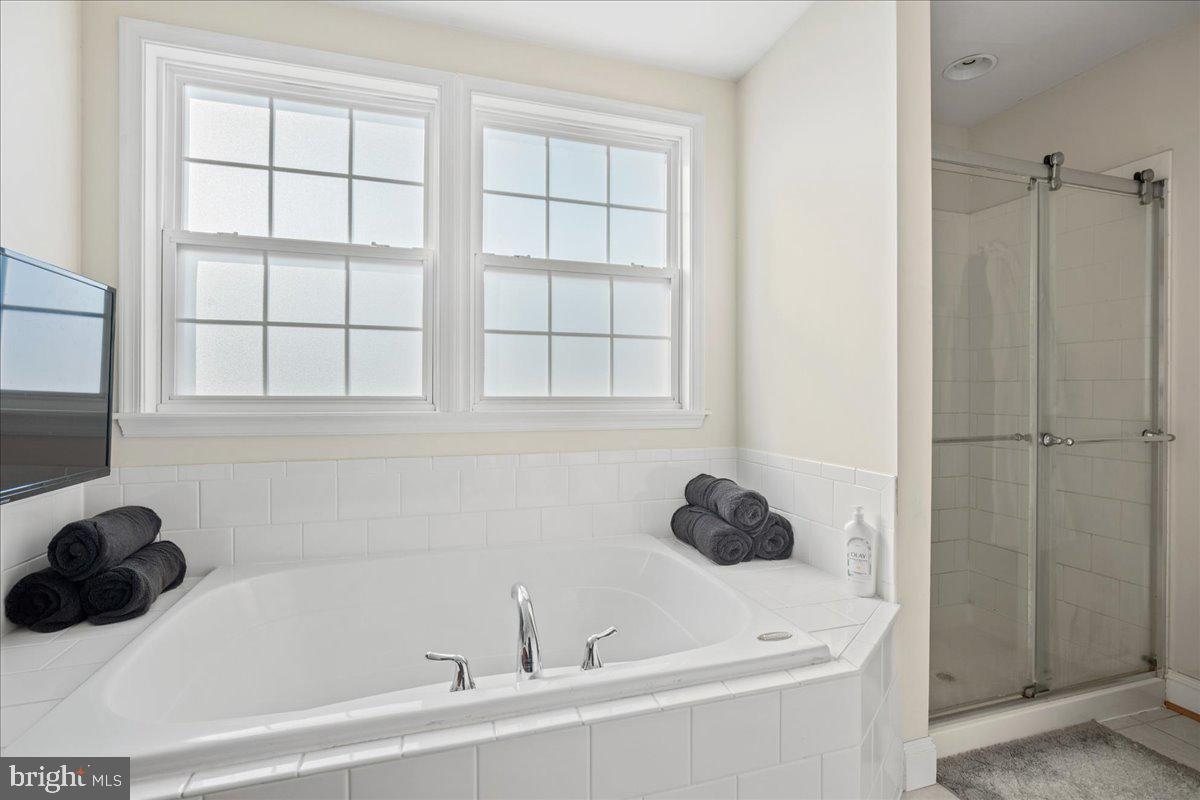8255 Longpoint Road Baltimore, MD 21222 - Photo 51 of 54 a bathroom with a tub sink and window