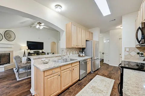 a kitchen with a sink stove and microwave