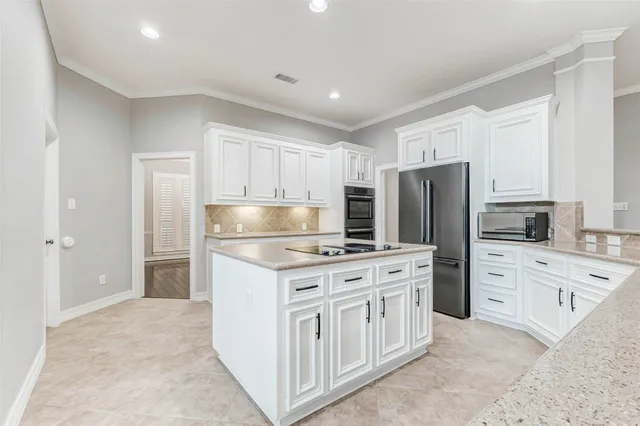 a kitchen with sink stove and cabinets