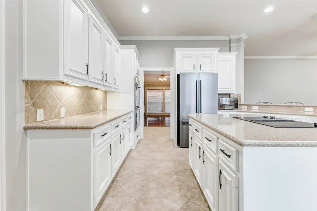 a kitchen with cabinets appliances and a counter space