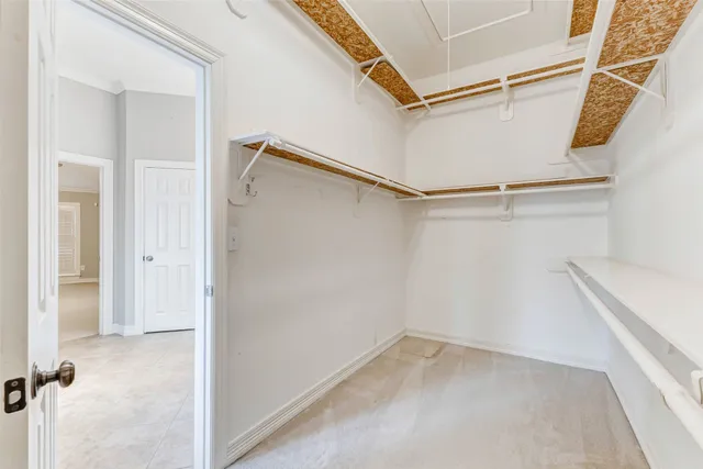 an empty room with wooden floor and window