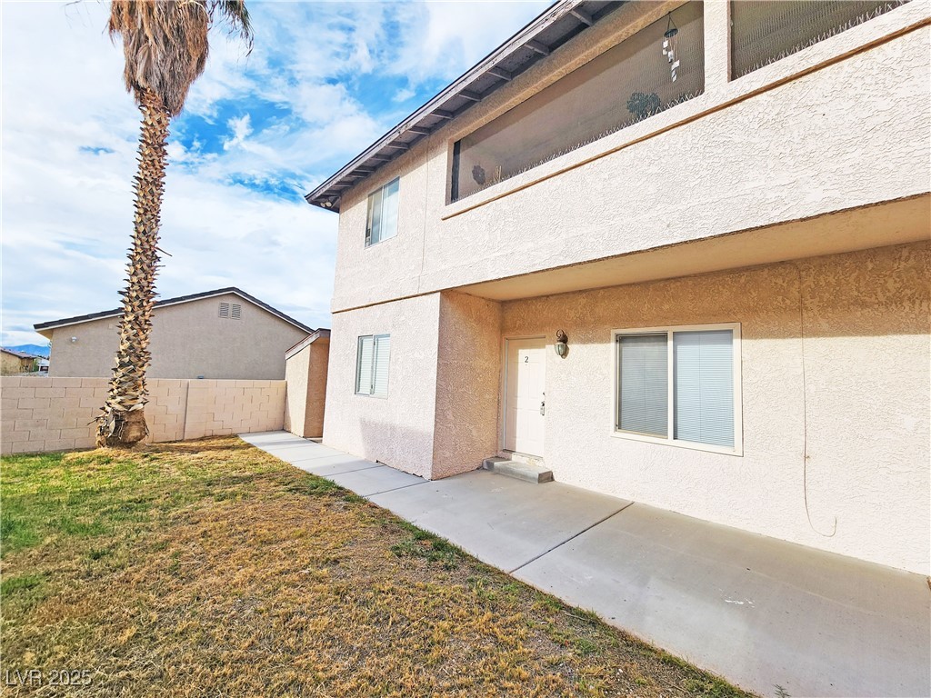 Entrance to property featuring stucco siding